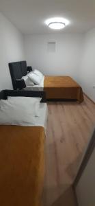 a room with two beds and a couch at Old Town Baska in Baška