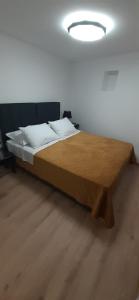 a bedroom with a wooden bed with a wooden table at Old Town Baska in Baška