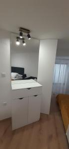 a white bathroom with a sink and a mirror at Old Town Baska in Baška