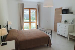 アグローポリにあるB&B Cilentumのベッドルーム1室(ベッド1台、ドレッサー、窓付)