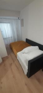 a bedroom with a bed with a wooden floor at Old Town Baska in Baška