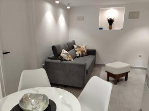 a living room with a couch and a table and chairs at Old Town Baska in Baška
