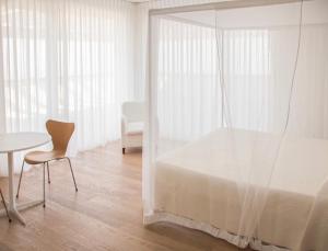 a bedroom with a bed and a table and a chair at Pianderna Agriwellness in Scandiano +24 photos