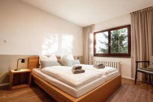 a bedroom with a large bed with towels on it at Ferienhaus Tannenblick Rochlitz in Rochlitz