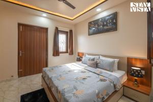 a bedroom with a large bed in a room at StayVista at The Binclave with Jacuzzi, Pvt Indoor Pool, Bar & Projector in Jaipur