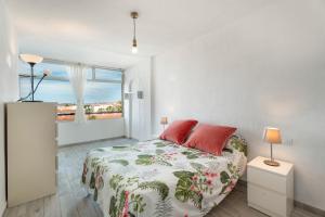 a white bedroom with a bed and a window at Casa Candido in Arona +16 photos