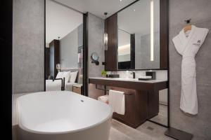 a bathroom with a white toilet and a sink at Wanda Jin Xiaohe Xincheng in Taiyuan