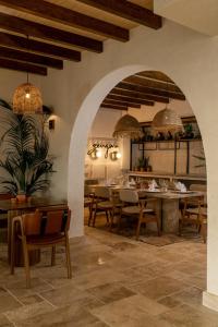 a dining room with a table and chairs and an archway at Radisson Blu Hotel, Kas in Kaş