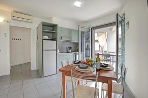 a kitchen and dining room with a table and chairs at Rosy & Onyx House With Shared Pool in Toscolano Maderno