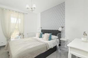 Posteľ alebo postele v izbe v ubytovaní Jasnoszary Apartament Sun Seasons 24 w Kołobrzegu Blisko Morza by Noclegi Renters