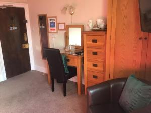 a room with a desk with a chair and a mirror at Hundalee House in Jedburgh