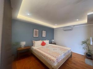 a bedroom with a bed and a blue wall at Apoheo Beach Cabin Free Use Motrbike Drng Stay in El Nido