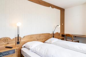 Postel nebo postele na pokoji v ubytování Hotel Chesa Grischa