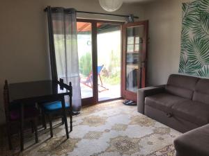 a living room with a couch and a table and a door at Kokin Brod Apartments in Kokin Brod