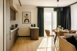 a kitchen and living room with a table and a dining room at Lake Bliss in Szczecinek