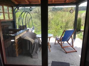 a room with a window and a chair and a table at Kokin Brod Apartments in Kokin Brod