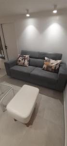 a living room with a couch and a white stool at Old Town Baska in Baška
