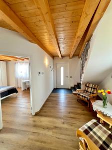 a large living room with a wooden ceiling at Sogno Blu - Levico in Levico Terme