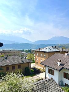 a view of a town with mountains in the background at Sogno Blu - Levico in Levico Terme