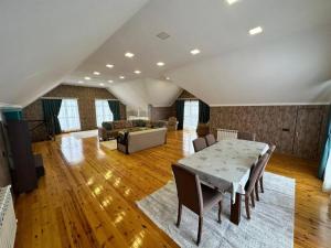a large living room with a table and a couch at ВИЛЛА / VILLA in Gabala