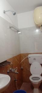 a bathroom with a toilet and a sink at Stay awhile in Ooty
