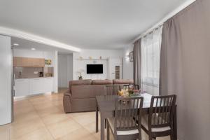 a living room with a table and a couch at Sunset Arguineguin in Arguineguín