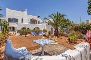 a patio with a table and chairs in front of a house at Sweet Family House in Cala d´Or