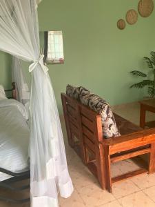 Postel nebo postele na pokoji v ubytování RUSINGA SUITES