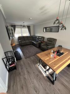 a living room with a couch and a table at 3 bedroom house, Caol, Fort William in Caol