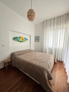 a bedroom with a bed in a white room at Limone Al Mare in Albenga