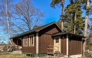 a small wooden cabin in the woods with trees at 1 Bedroom Stunning Home In Gamleby in Gamleby