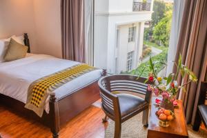 Postel nebo postele na pokoji v ubytování La Rose Suites