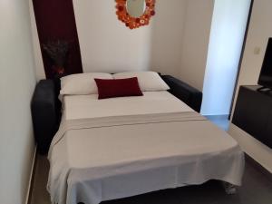 a bedroom with a bed with a red pillow on it at Old Town Baska in Baška