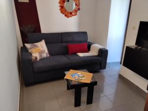 a living room with a couch and a coffee table at Old Town Baska in Baška