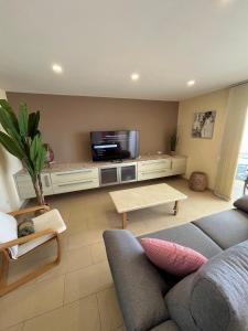 a living room with a couch and a tv at Bungalow Sun terrace 360º Relax in Los Realejos