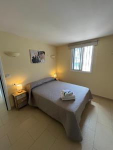 a bedroom with a bed with two towels on it at Bungalow Sun terrace 360º Relax in Los Realejos