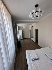 a white room with a bed and a hallway at Антей Большой in Koshkolʼ