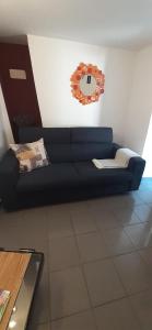 a blue couch in a living room with a mirror at Old Town Baska in Baška