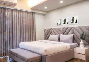 a bedroom with a king sized bed and a couch at Housr Sector 41 Near Fortis Hospital in Gurgaon