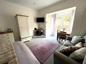 a living room with a couch and a table and window at The Gantocks in Fort William