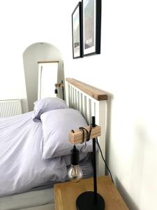a bedroom with a bed and a table with a lamp at The Gantocks in Fort William