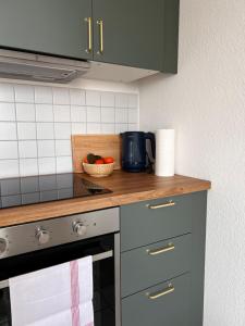 a kitchen with a counter top with a bowl of fruit at City-View Studio with Balcony, Dessau in Dessau