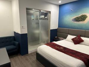 a bedroom with a bed and a glass shower at HOTEL KIS 14 Xã Đàn in Hanoi