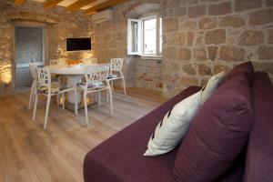 a living room with a couch and a table at Villa Veli Varos in Split