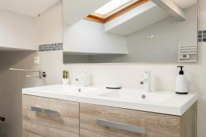 a bathroom with a white sink and a mirror at La Longere Chateau Vieux Mougnac in Petit-Palais-et-Cornemps +25 photos