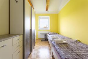a bedroom with a bed and a yellow wall at Apartma Majdas in Loka pri Mengšu +14 photos