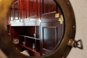 a mirror with a reflection of a cabinet at Il Giardino Segreto in Bellagio