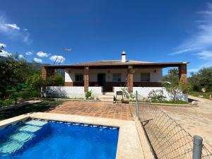 ein Haus mit einem Swimmingpool davor in der Unterkunft Finca el Pereo in Alhaurín el Grande