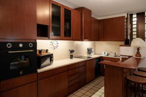 a kitchen with wooden cabinets and a stove top oven at Il Giardino Segreto in Bellagio +12 photos