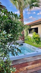 a jacuzzi tub in the backyard of a house at Villa Miroir d'O in Gujan-Mestras
